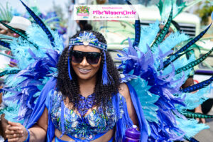 Documentary poster for "Culture vs. Commerce," featuring vibrant scenes from the 2015 Bahamas Junkanoo Carnival. The image displays a montage of traditional Junkanoo masqueraders in intricate cardboard costumes alongside modern Carnival revelers in feathered "Road Fever" attire, set against a backdrop of the Nassau street parade at night.