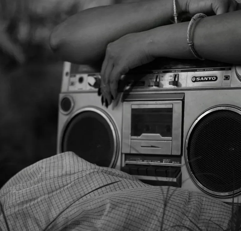 A professional radio broadcasting setup featuring a high-end microphone and DIRadioCast branding, symbolizing twenty years of independent media architecture and community-first digital storytelling.